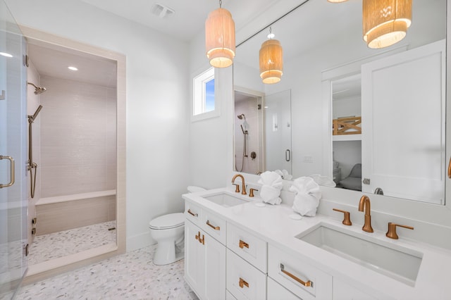 bathroom with toilet, a shower stall, visible vents, and a sink