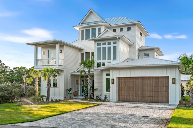 view of front of house featuring a balcony, decorative driveway, and board and batten siding