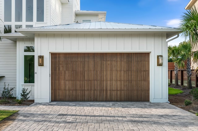 garage featuring decorative driveway