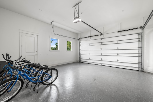 garage with baseboards and a garage door opener