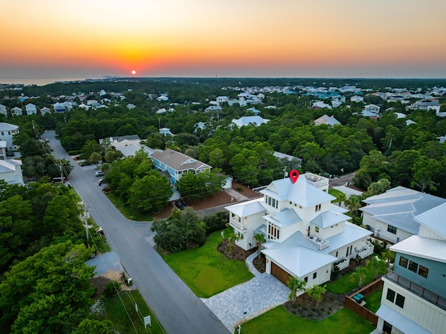 aerial view at dusk featuring a residential view