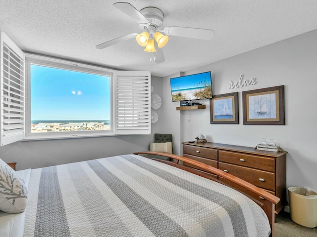 bedroom with a textured ceiling and a ceiling fan