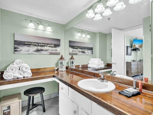 bathroom featuring a textured ceiling, vanity, and tile patterned floors