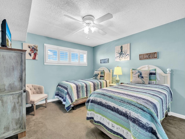 carpeted bedroom with ceiling fan, baseboards, and a textured ceiling