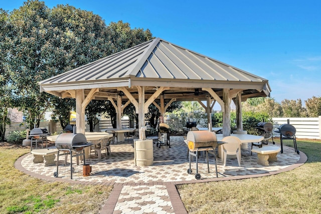 view of home's community with a yard, a patio area, fence, and a gazebo