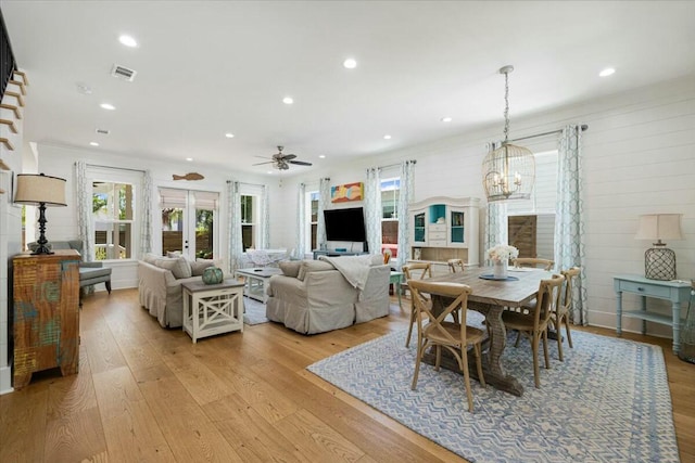 dining space with french doors, light wood-type flooring, visible vents, and a healthy amount of sunlight