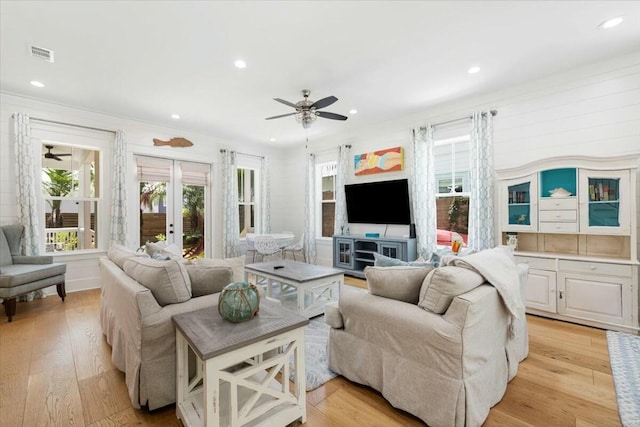 living room featuring ceiling fan, french doors, light wood finished floors, and visible vents