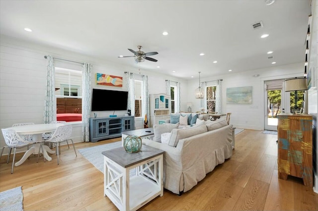 living room featuring light wood-style floors, recessed lighting, and visible vents