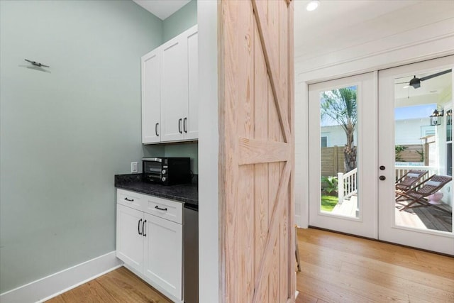 kitchen featuring light wood-style floors, french doors, a healthy amount of sunlight, and baseboards