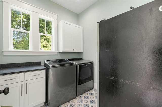 laundry area with washer and clothes dryer and cabinet space