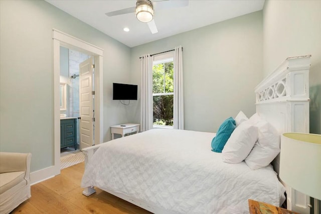 bedroom with recessed lighting, a ceiling fan, baseboards, light wood finished floors, and ensuite bath