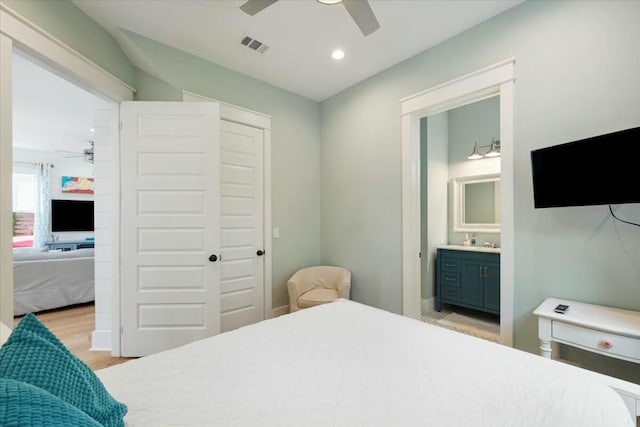 bedroom featuring recessed lighting, a closet, visible vents, light wood-style floors, and ensuite bath