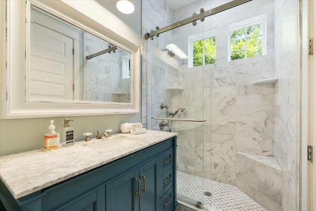 bathroom with a shower stall and vanity