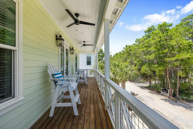 wooden deck with ceiling fan and a porch