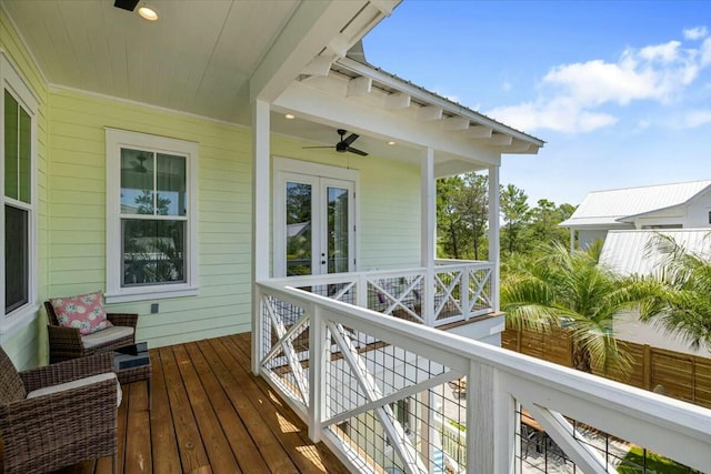 wooden deck featuring ceiling fan