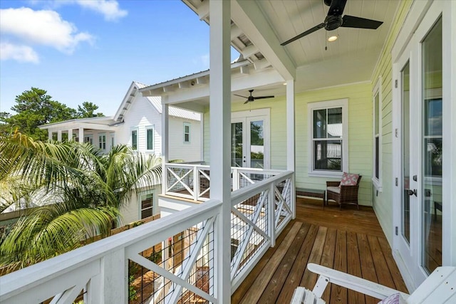 wooden deck featuring a ceiling fan and french doors