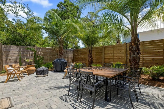 view of patio with a fenced backyard, grilling area, and outdoor dining space