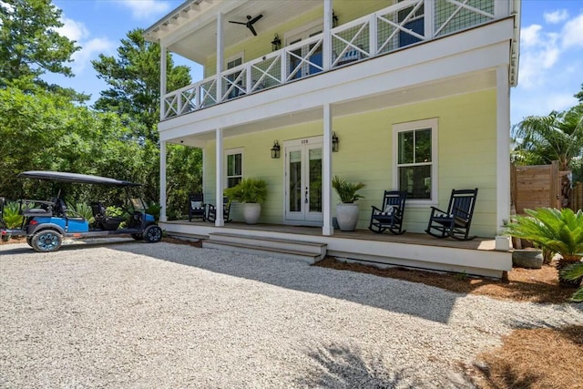 back of property featuring a balcony and french doors