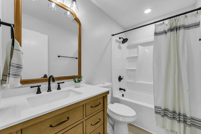 bathroom featuring toilet, vanity, and shower / bath combo