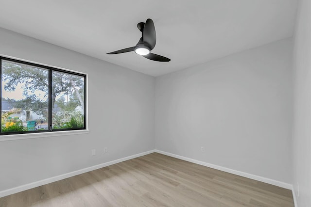 unfurnished room with light wood-style floors, baseboards, and ceiling fan