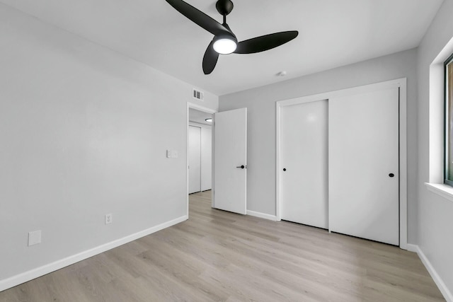 unfurnished bedroom with visible vents, baseboards, and light wood-style flooring