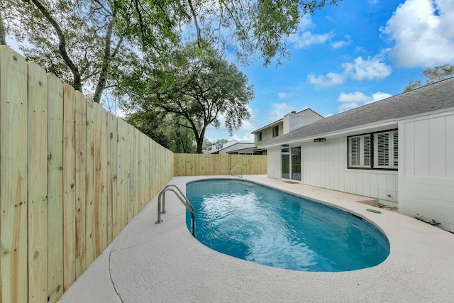 view of swimming pool featuring a patio area, a fenced in pool, and a fenced backyard