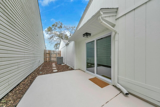 view of patio featuring central AC and fence