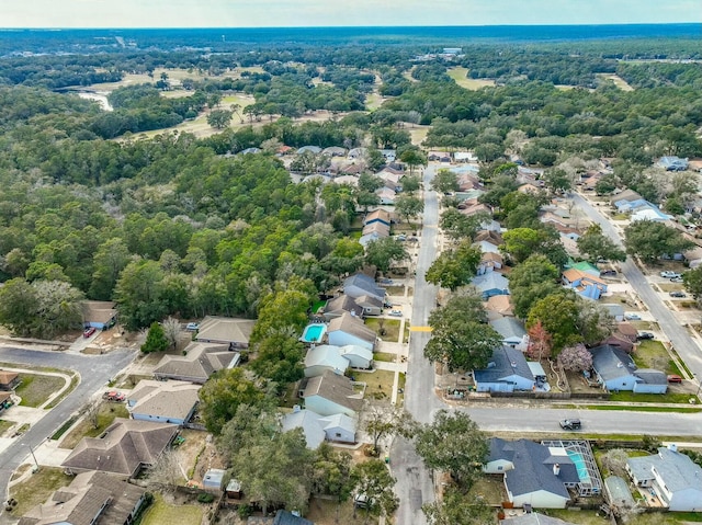 aerial view featuring a forest view and a residential view