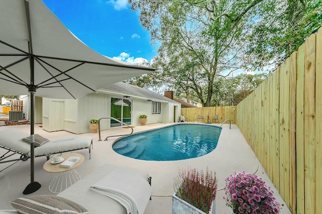 view of swimming pool with a patio area, a fenced in pool, central AC, and a fenced backyard