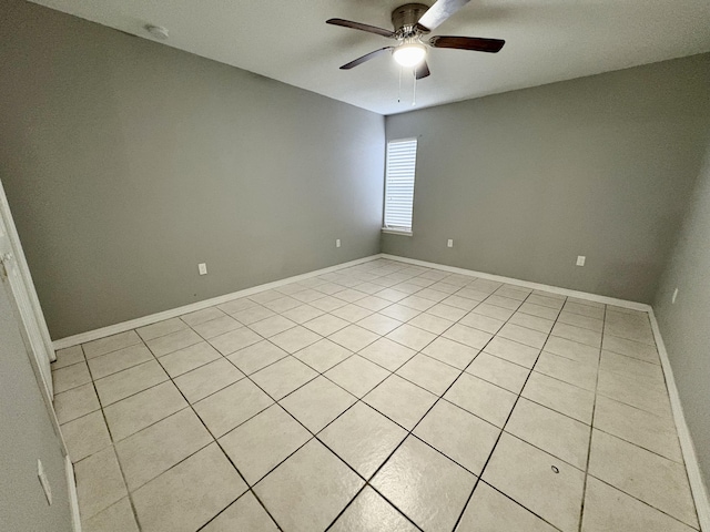 unfurnished room featuring ceiling fan and baseboards