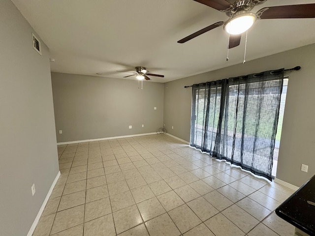 spare room featuring visible vents, baseboards, and light tile patterned flooring