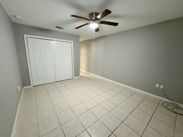 unfurnished bedroom featuring a ceiling fan, a closet, visible vents, and baseboards