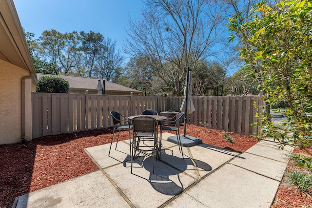 view of patio with outdoor dining area and a fenced backyard