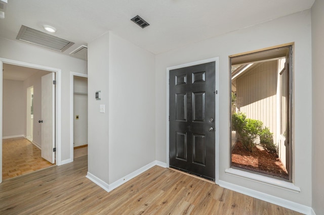 entrance foyer with light wood-style flooring, baseboards, and visible vents