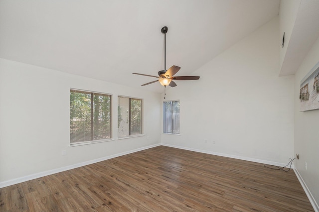 empty room featuring high vaulted ceiling, wood finished floors, baseboards, and ceiling fan