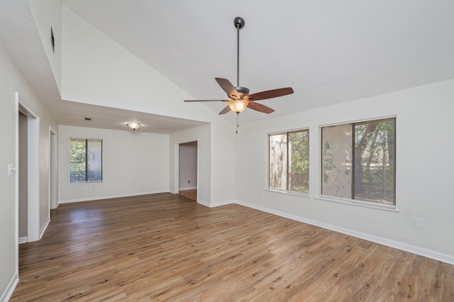 spare room featuring baseboards, light wood finished floors, and ceiling fan