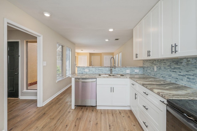 kitchen with light wood-type flooring, a sink, white cabinets, light stone countertops, and dishwasher