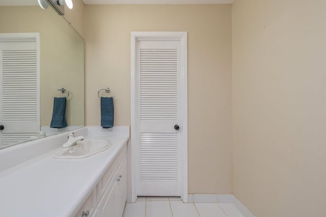 bathroom with tile patterned flooring, vanity, and baseboards