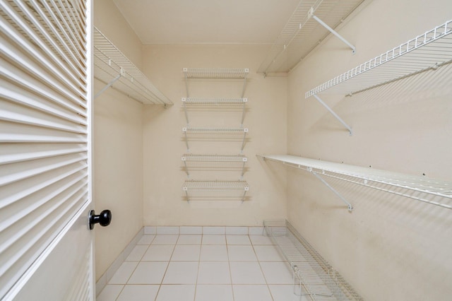 walk in closet featuring tile patterned flooring