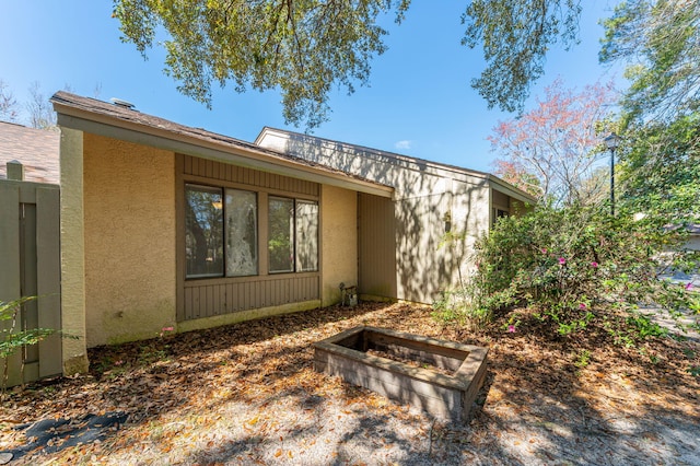 rear view of house with stucco siding