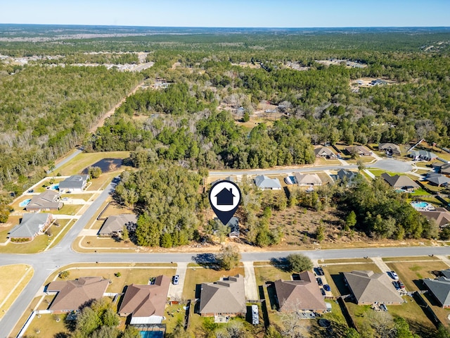 drone / aerial view with a residential view and a wooded view