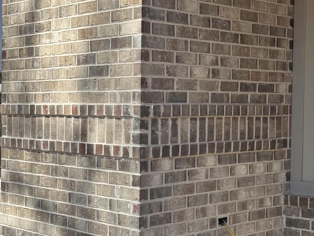 exterior details featuring brick siding