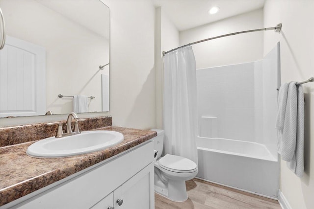 full bathroom featuring shower / bath combo with shower curtain, toilet, vanity, and wood finished floors