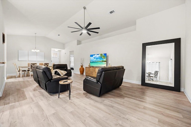 living room with baseboards, visible vents, light wood finished floors, lofted ceiling, and ceiling fan with notable chandelier