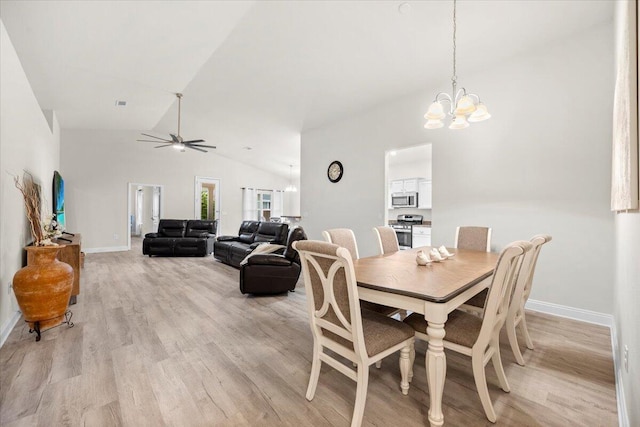 dining area with baseboards, lofted ceiling, light wood-style floors, and visible vents