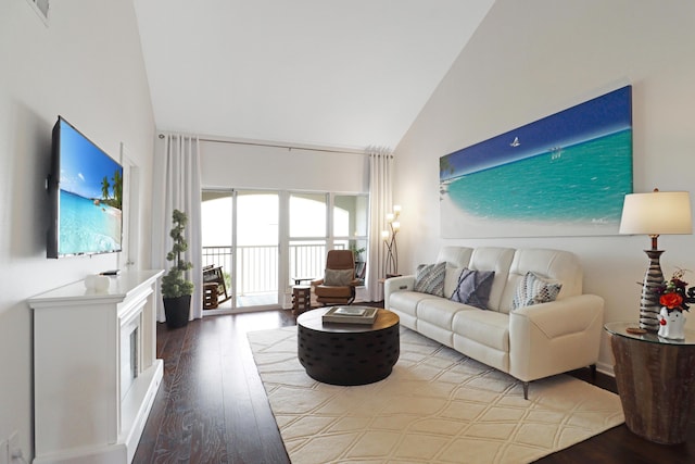 living room with high vaulted ceiling and wood finished floors