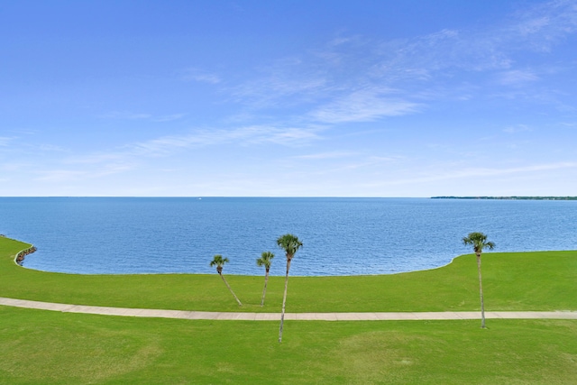 surrounding community with a lawn and a water view