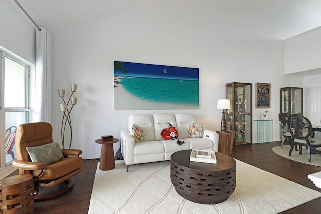 living area with baseboards and wood finished floors