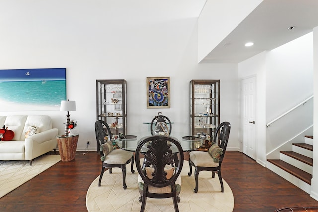 dining room featuring stairway, recessed lighting, baseboards, and wood finished floors