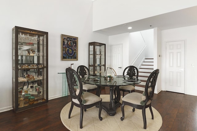 dining area featuring stairs, wood finished floors, and baseboards